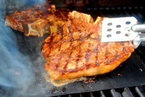 Meat being grilled on a Kona grill mat