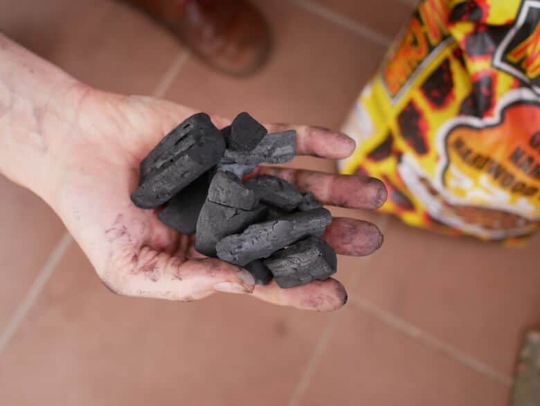 Benoit holding some charcoal in his hand